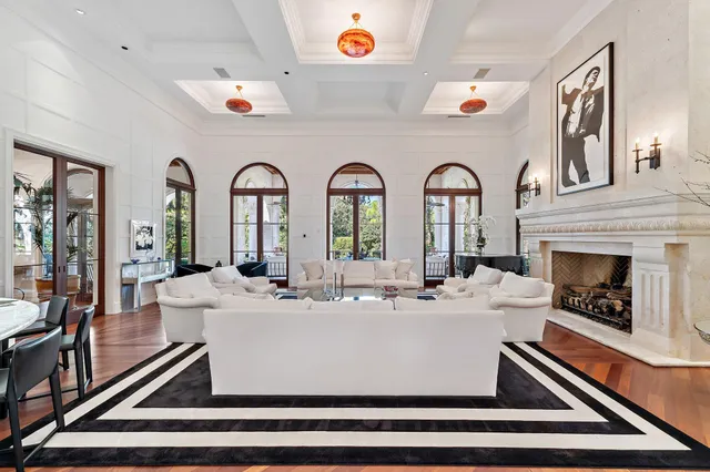 a spacious bathroom with a tub sink double vanity windows and a chandelier