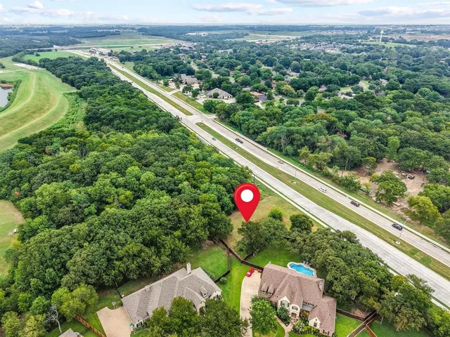 a view of a city with lush green forest