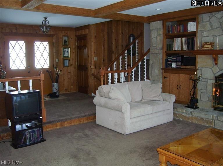 Welcome your guests in this large foyer overlooking cedar paneled Great Room with raised hearth stone gas-log firplace.