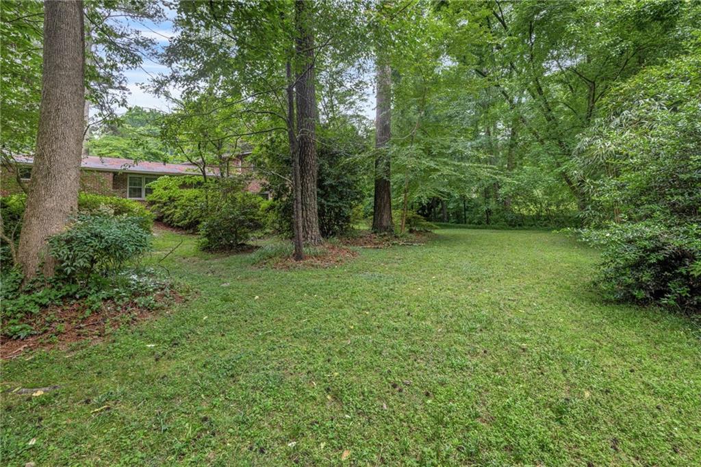 1911 Alderbrook Road Northeast Atlanta, GA 30345 - Photo 31 of 33 a view of a grassy field with trees in the background
