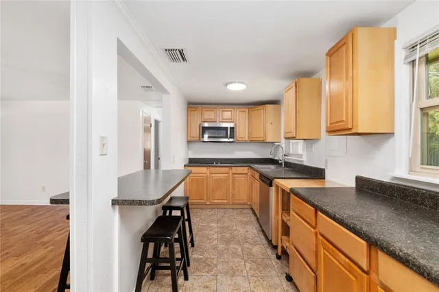 a kitchen with wooden cabinets and center island