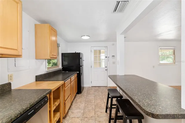 a kitchen with granite countertop sink table and chairs