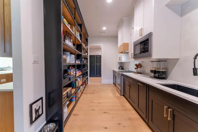 a kitchen with stainless steel appliances granite countertop lots of counter top space and cabinets
