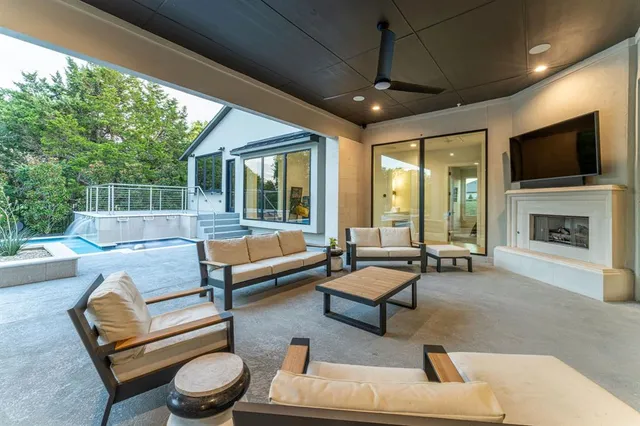 a living room with furniture pool table and a fireplace