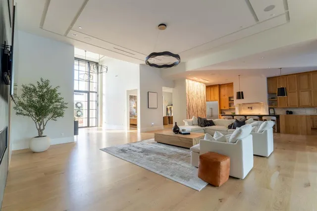 a living room with fireplace furniture and a large window