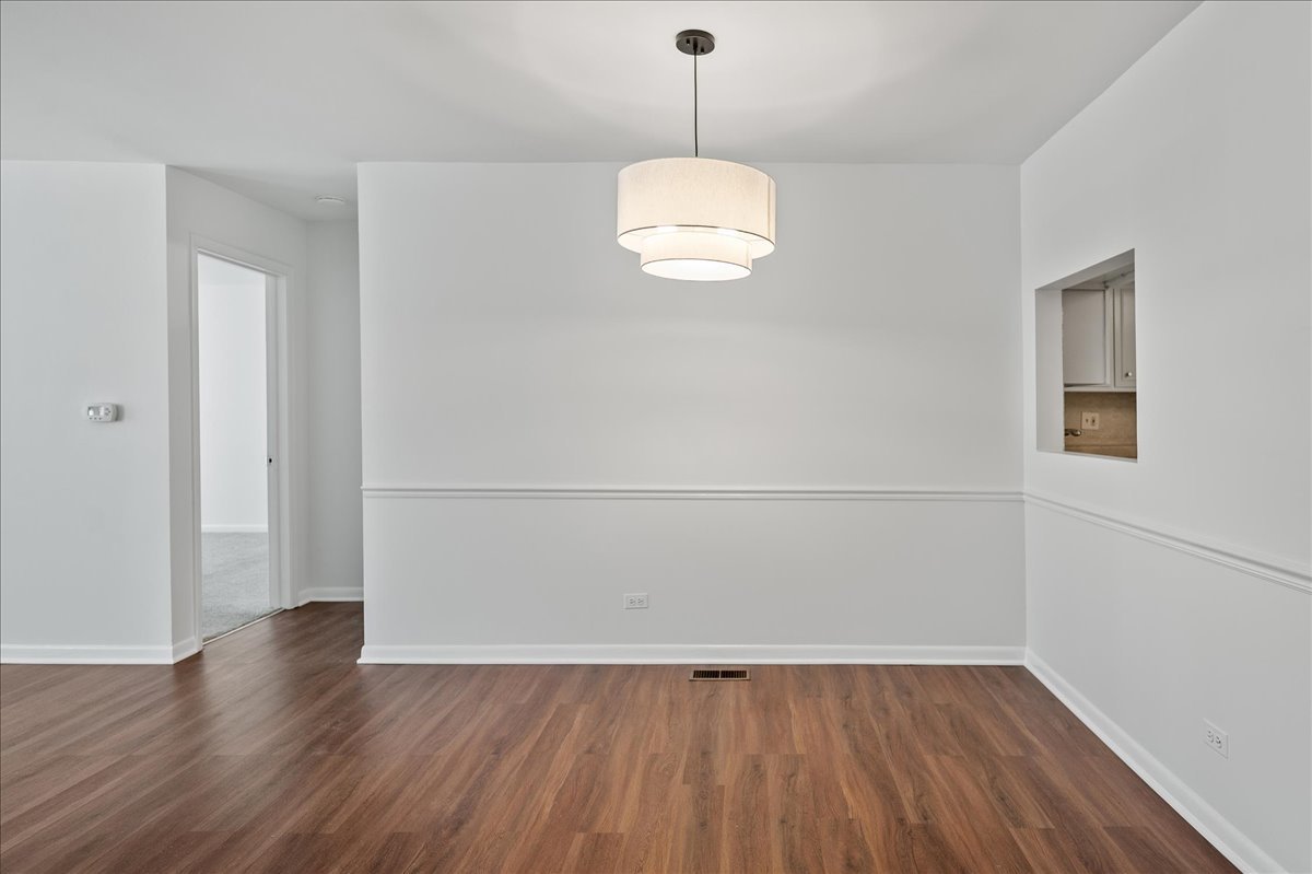 715 Ridge Road, Unit 1BN Wilmette, IL 60091 - Photo 4 of 15 a view of a room with wooden floor and white walls