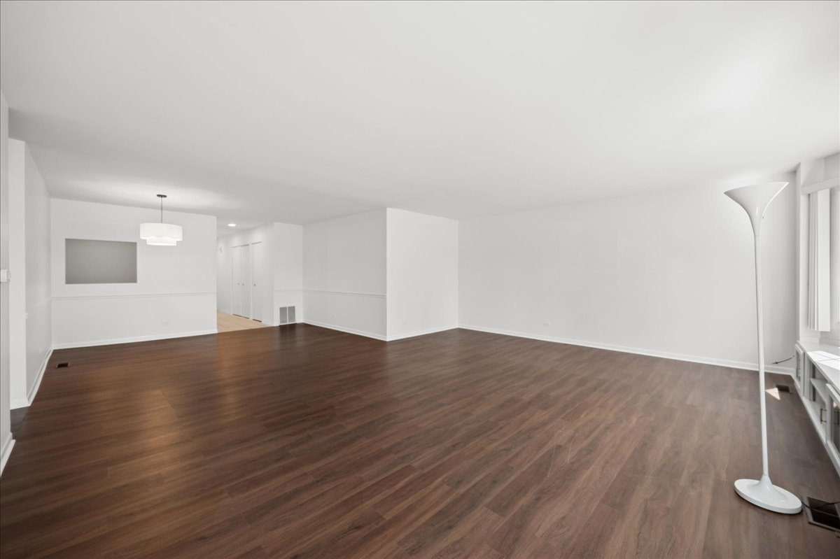 715 Ridge Road, Unit 1BN Wilmette, IL 60091 - Photo 9 of 15 an empty room with wooden floor and windows