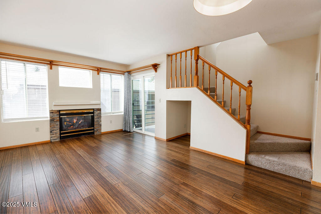 600 Nottingham Road, Unit 15 Avon, CO 81620 - Photo 4 of 10 a view of a livingroom with wooden floor and fireplace