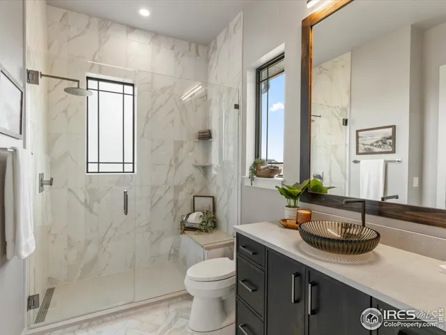 a bathroom with a sink and mirror with toilet