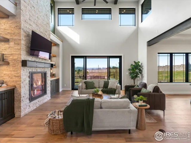 a living room with fireplace furniture and a flat screen tv