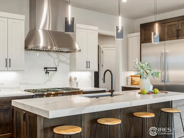 a kitchen with stainless steel appliances a sink and a stove
