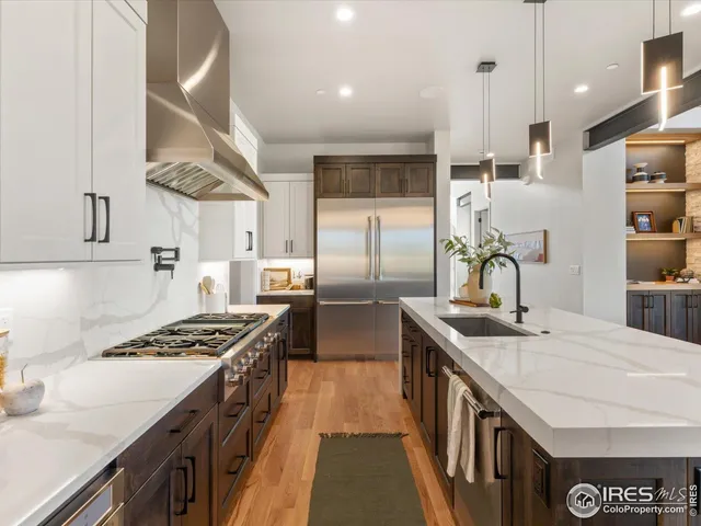 a kitchen with stainless steel appliances a sink a stove and a refrigerator