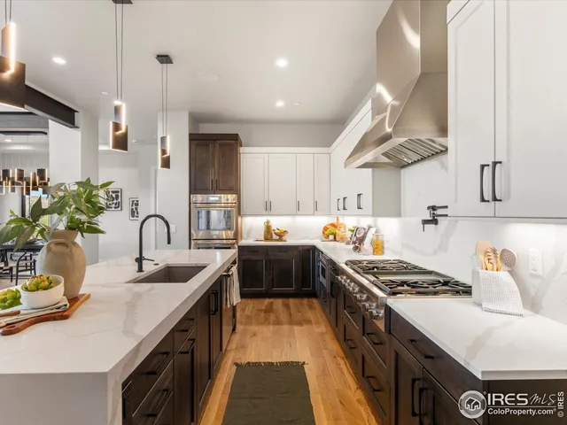 a kitchen with stainless steel appliances granite countertop a sink stove and cabinets