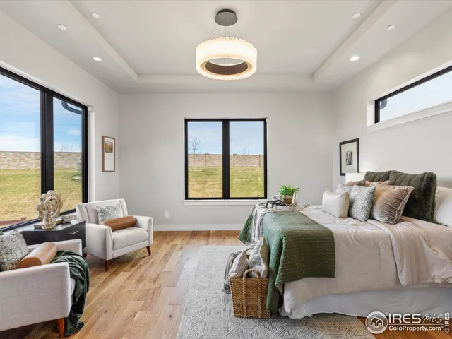 a bedroom with two beds and a large window