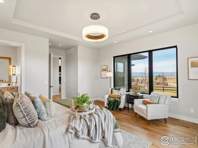 a bedroom with furniture and a large window