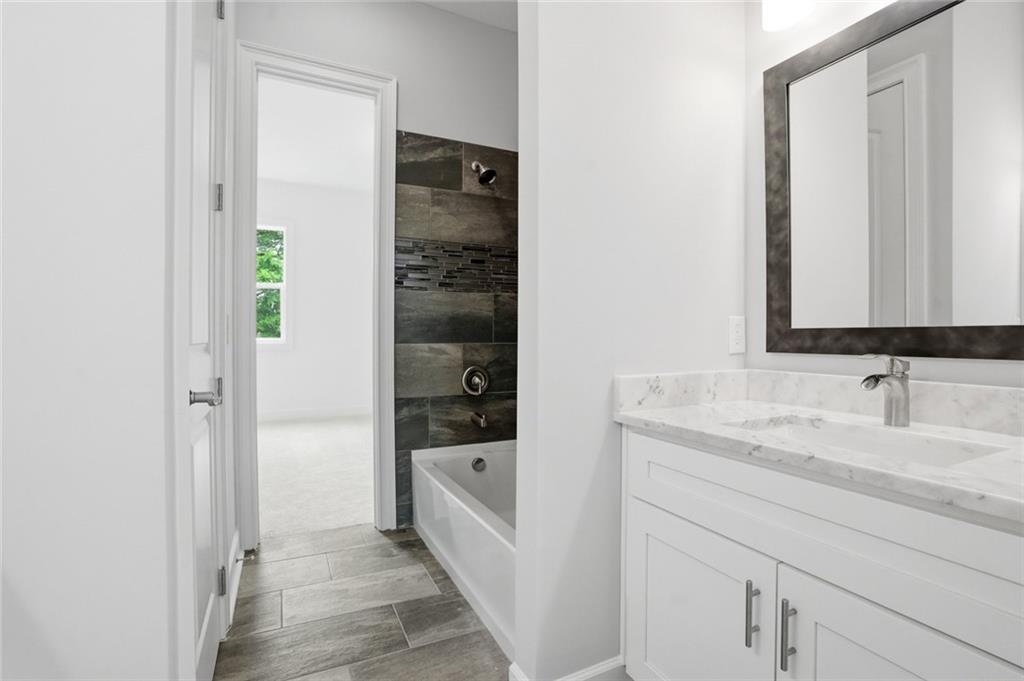 2415 West Rugby Avenue Atlanta, GA 30337 - Photo 33 of 40 a bathroom with a sink and a mirror