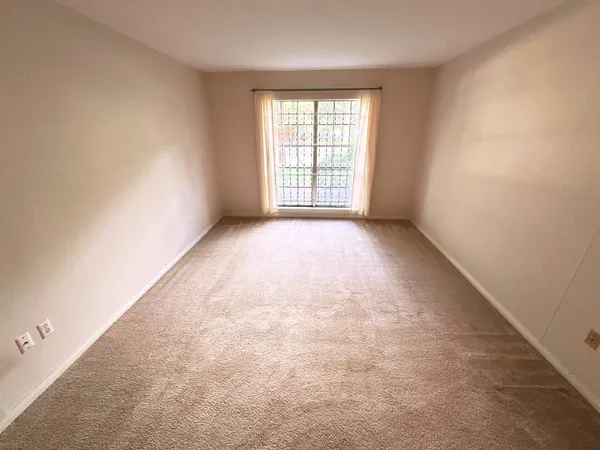 a view of a hallway with wooden floor and a door