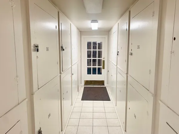 a bathroom with a shower and closet