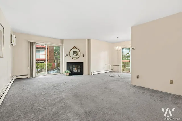 an empty room with furniture and a fireplace