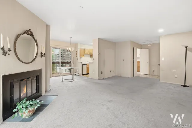 a view of a livingroom with furniture a fireplace and window