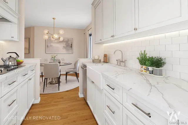 a spacious kitchen with stainless steel appliances kitchen island granite countertop a sink and cabinets