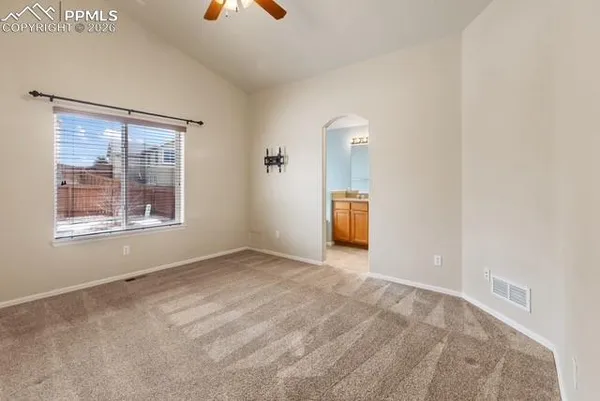 an empty room with a window and fireplace