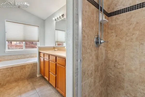 a bathroom with a tub sink and mirror