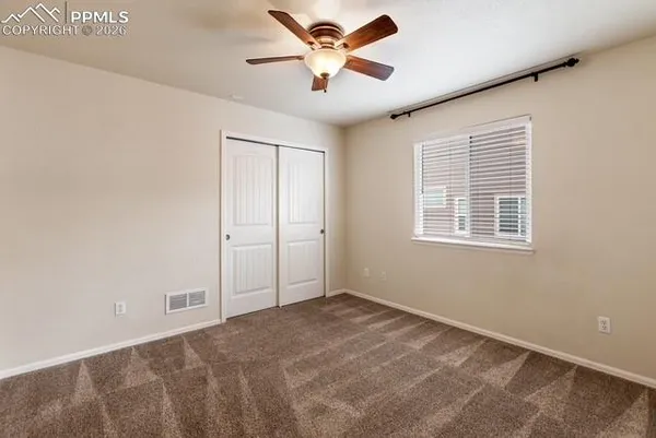 a view of a livingroom with a ceiling fan and window