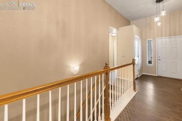 a view of a hallway with wooden floor