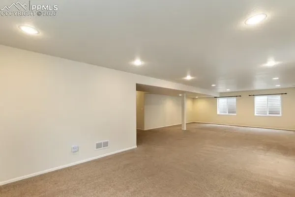 an empty room with windows and pillars in it