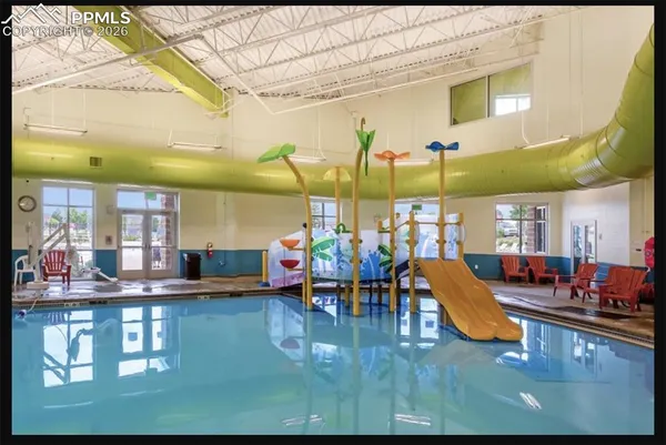 a view of a swimming pool with outdoor seating