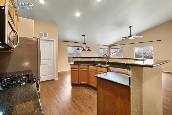 a kitchen with a sink appliances and cabinets