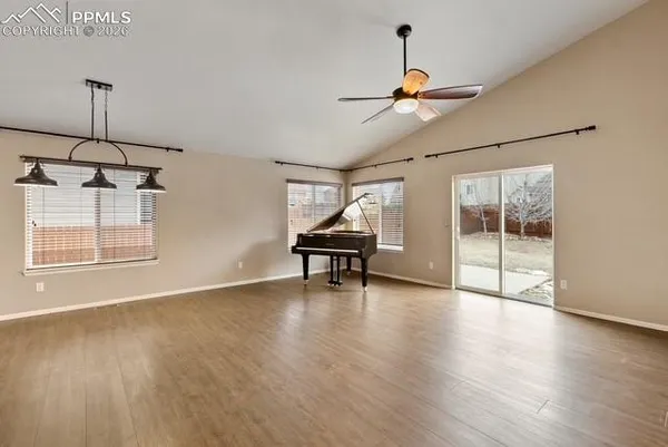a view of a livingroom with wooden floor and a ceiling fan