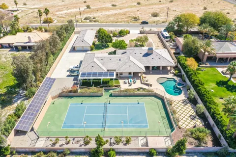 an aerial view of a house with a swimming pool