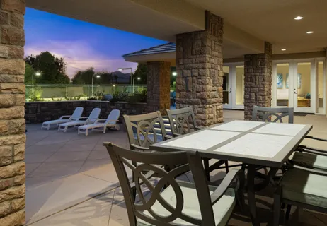 a view of a patio with a dining table and chairs