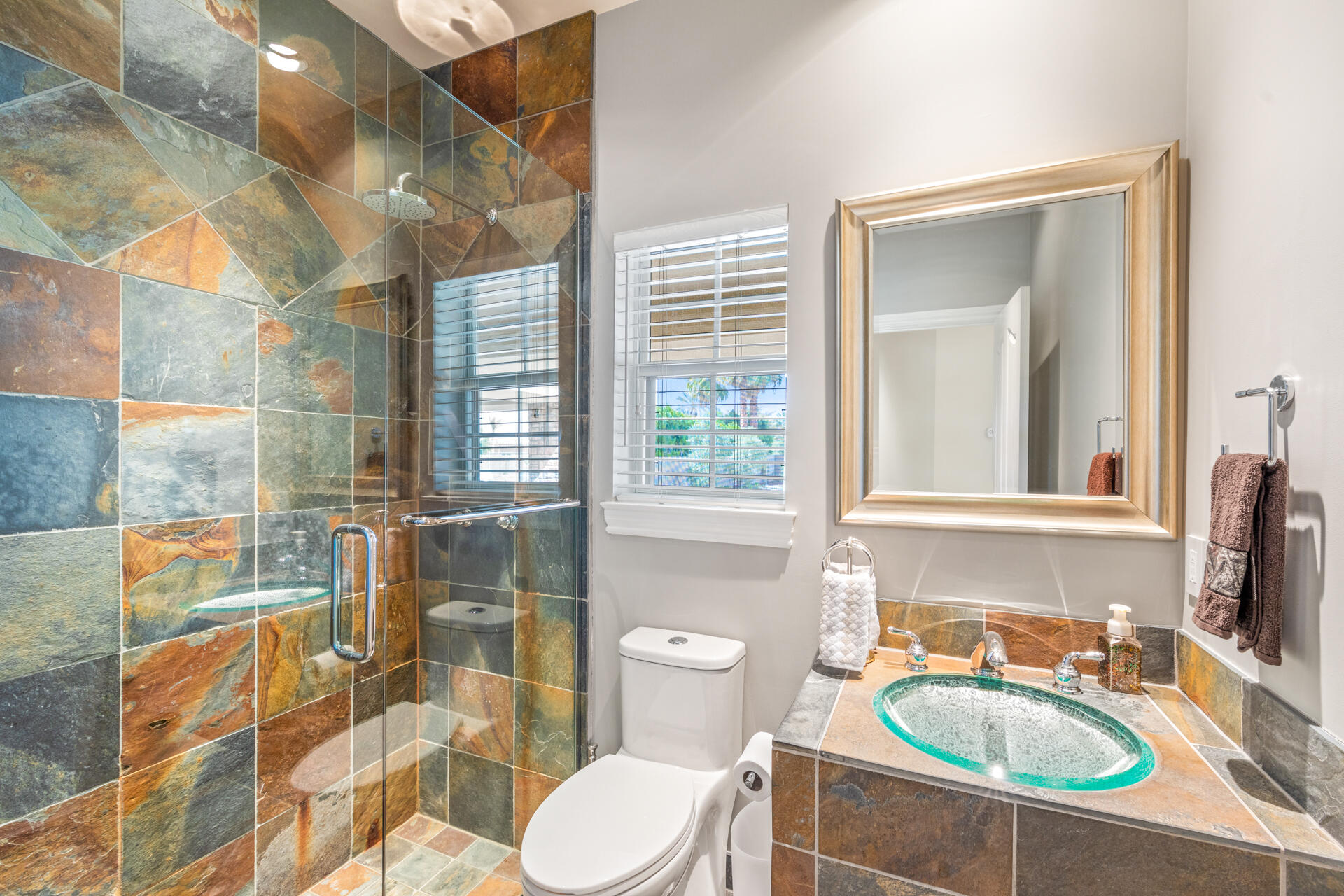 34777 Via Josefina Rancho Mirage, CA 92270 - Photo 21 of 47 a bathroom with a sink a toilet a mirror and next to a window