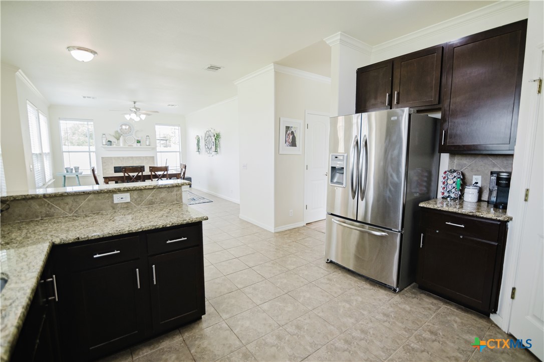 201 Boulder Ridge Drive Cuero, TX 77954 - Photo 12 of 37 a kitchen with stainless steel appliances granite countertop a refrigerator a stove a sink and a microwave