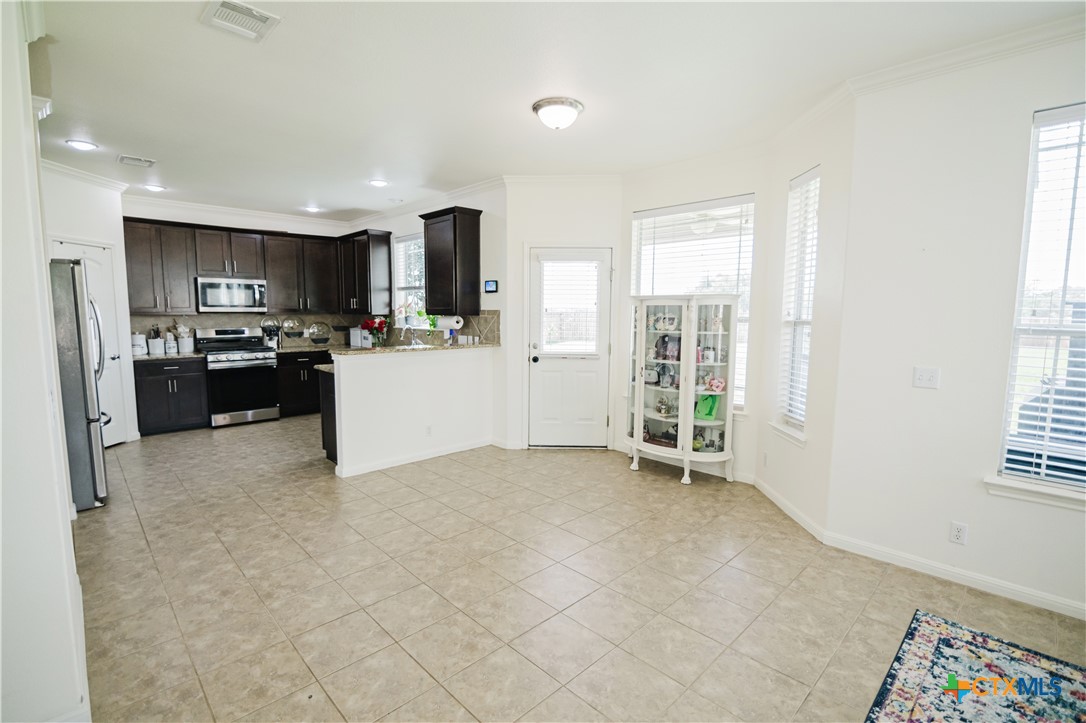 201 Boulder Ridge Drive Cuero, TX 77954 - Photo 14 of 37 a view of kitchen with refrigerator stove and microwave