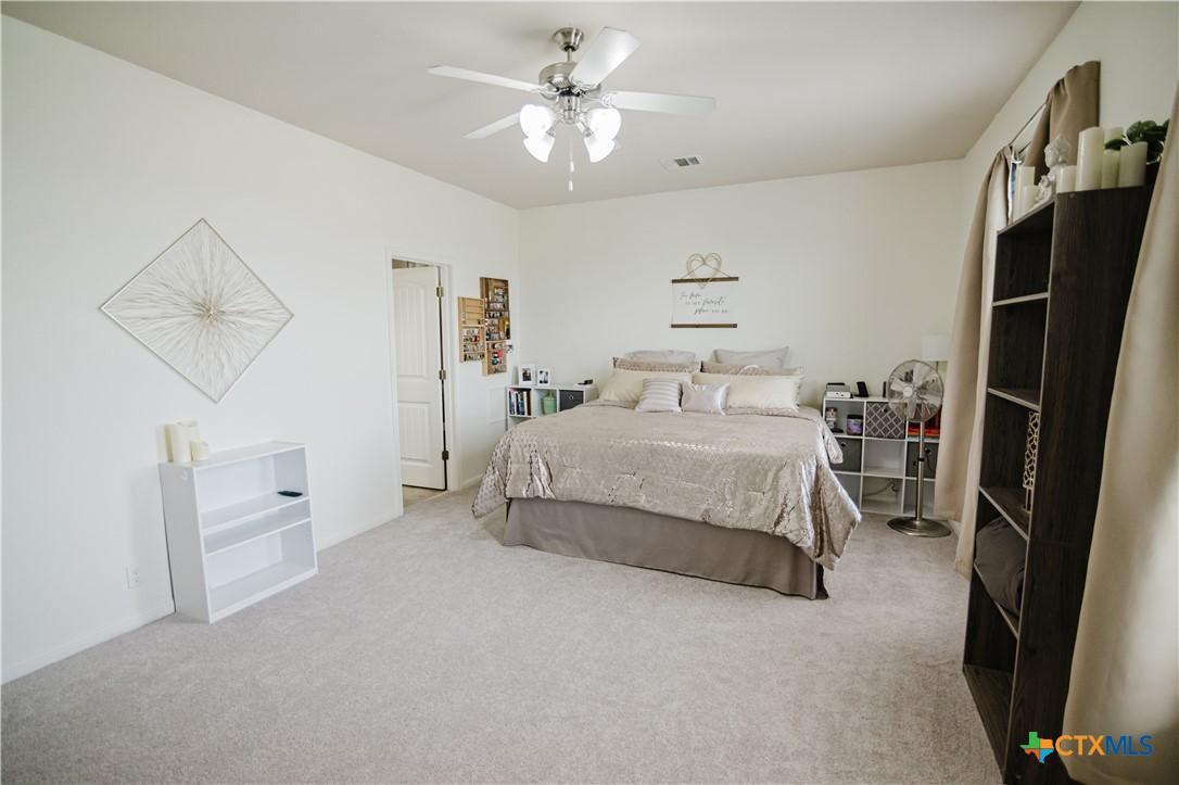 201 Boulder Ridge Drive Cuero, TX 77954 - Photo 19 of 37 a spacious bedroom with a bed and a walk in closet