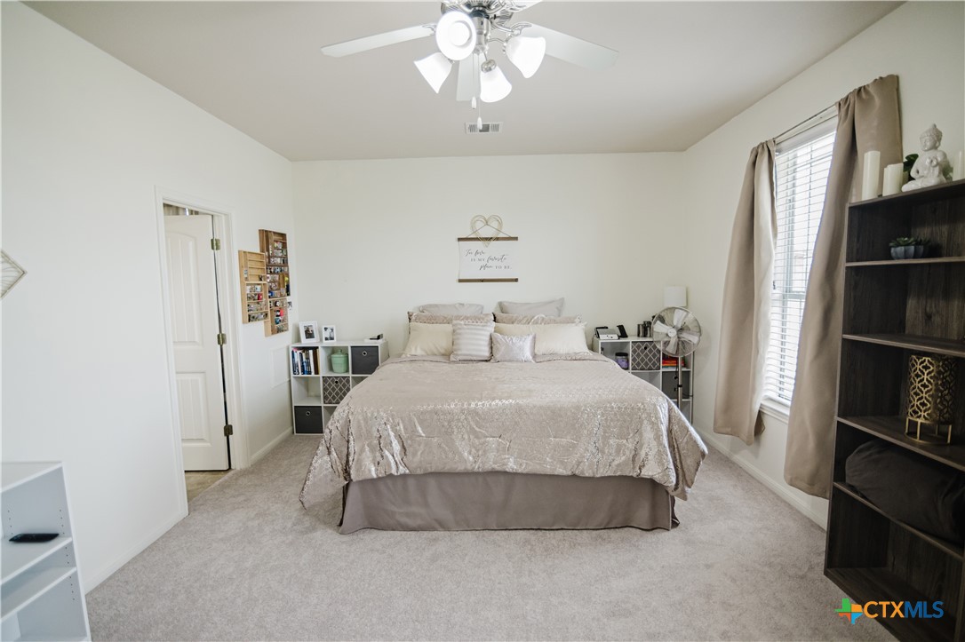 201 Boulder Ridge Drive Cuero, TX 77954 - Photo 20 of 37 a bedroom with a bed and a book shelf