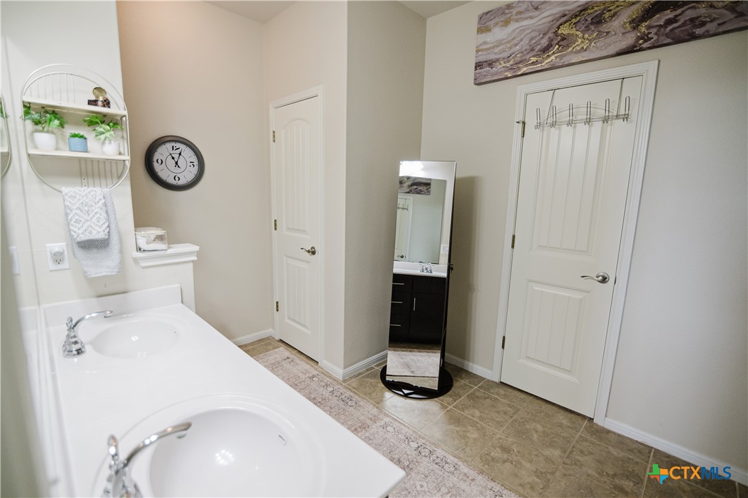 201 Boulder Ridge Drive Cuero, TX 77954 - Photo 21 of 37 a bathroom with a sink and a mirror