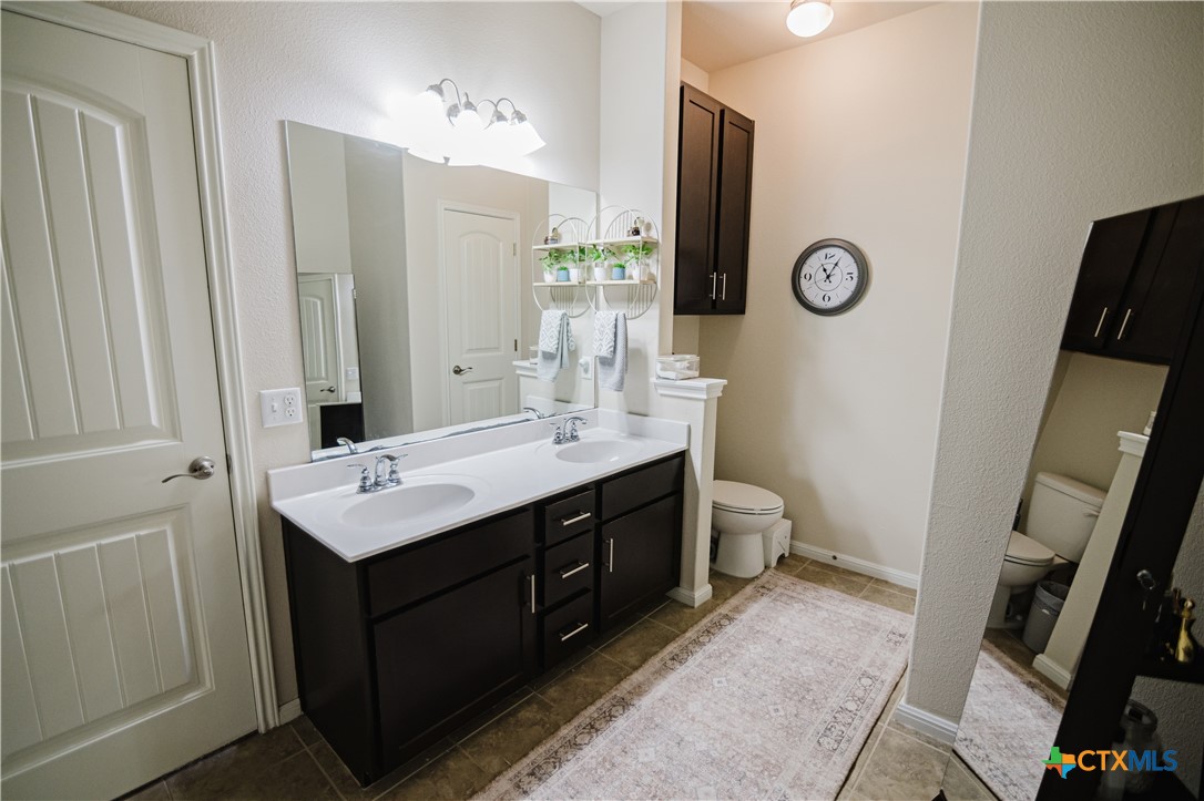 201 Boulder Ridge Drive Cuero, TX 77954 - Photo 23 of 37 a bathroom with a double vanity sink mirror and toilet