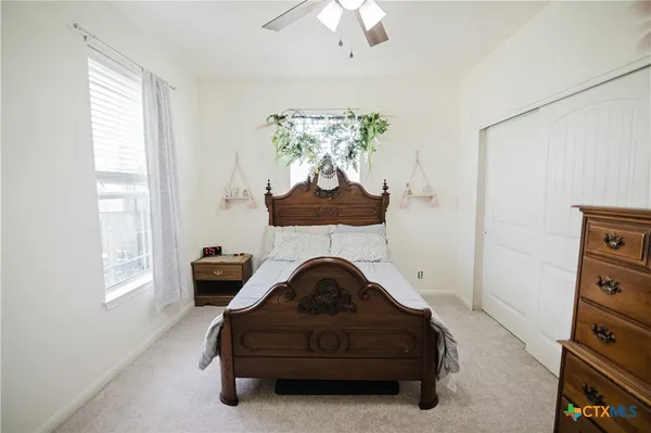 a bedroom with a bed and a bookshelf