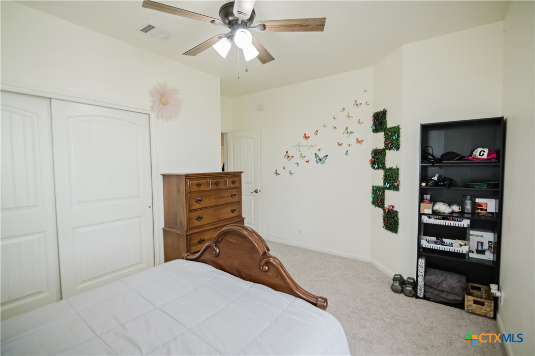 201 Boulder Ridge Drive Cuero, TX 77954 - Photo 25 of 37 a bedroom with a bed and a bookshelf