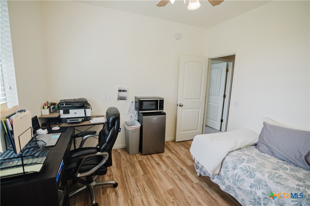 201 Boulder Ridge Drive Cuero, TX 77954 - Photo 27 of 37 a bedroom with a bed and a desk