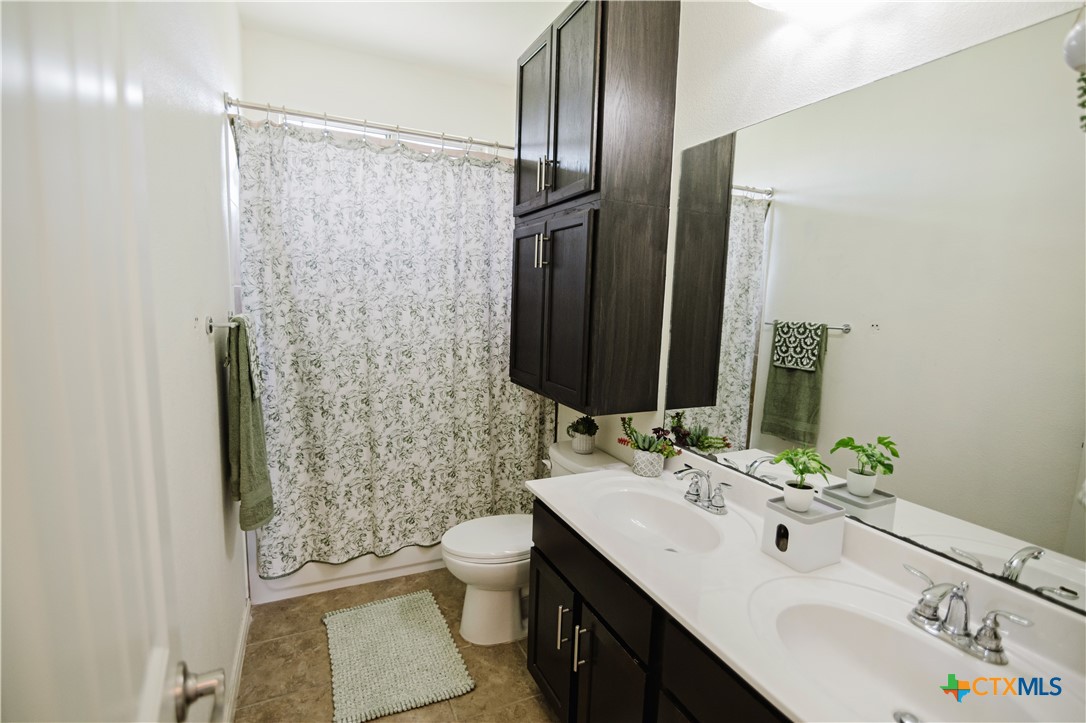 201 Boulder Ridge Drive Cuero, TX 77954 - Photo 30 of 37 a bathroom with a sink toilet and shower