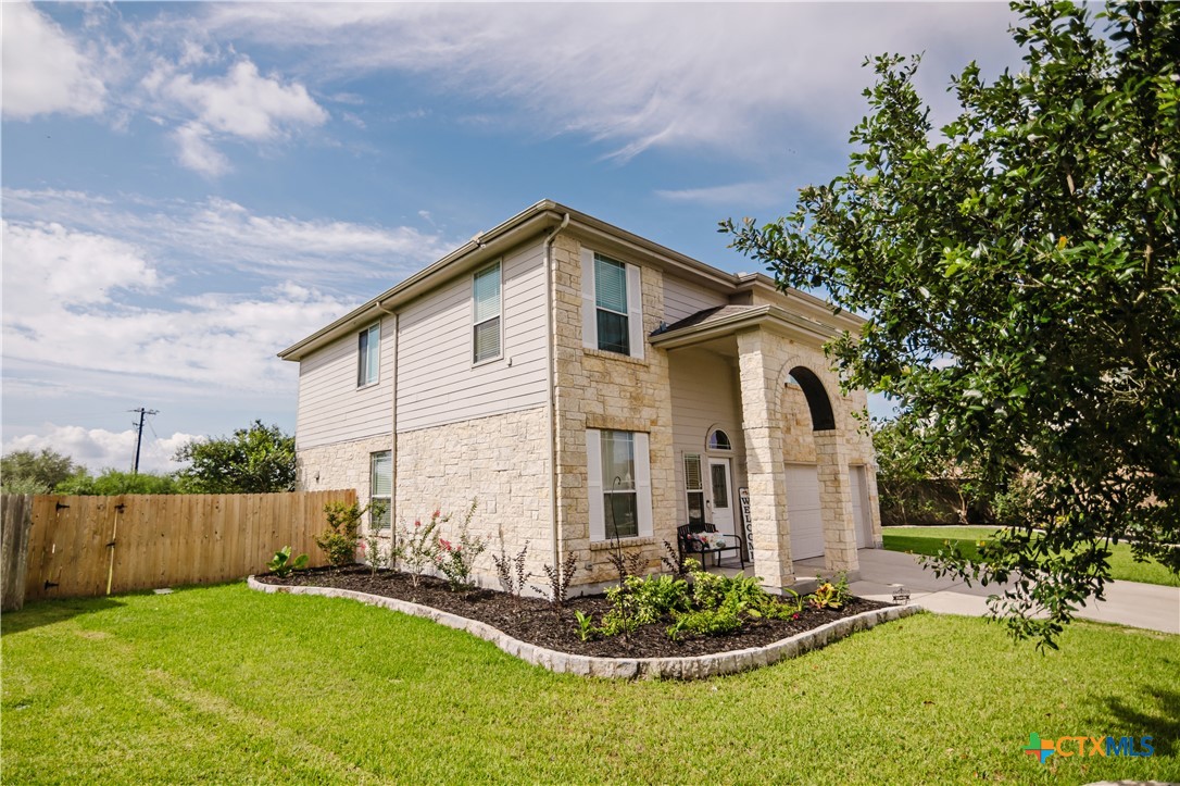 201 Boulder Ridge Drive Cuero, TX 77954 - Photo 3 of 37 a front view of a house with a yard and garage
