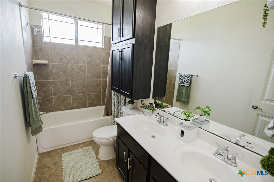 201 Boulder Ridge Drive Cuero, TX 77954 - Photo 31 of 37 a bathroom with a bathtub shower sink vanity mirror and toilet