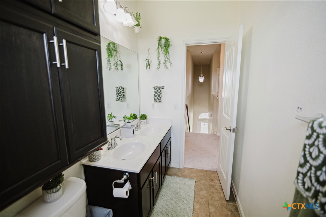 201 Boulder Ridge Drive Cuero, TX 77954 - Photo 32 of 37 a bathroom with a sink and mirror