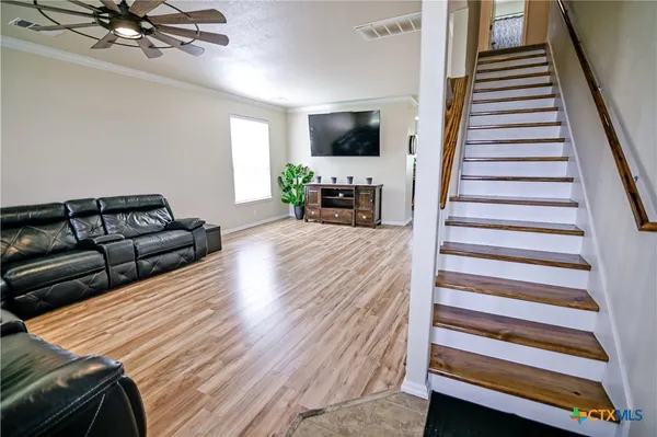 a living room with furniture and a flat screen tv